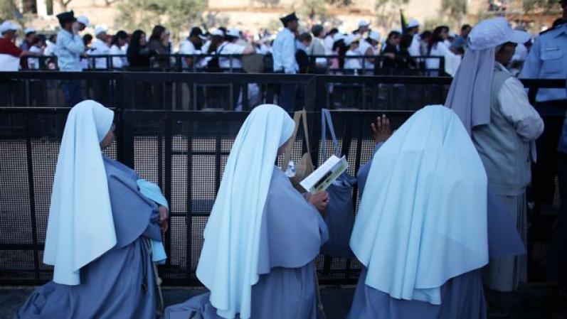 JERUSALEM - MAY 12: (ISRAEL OUT) Nuns pray as Pope Benedict celebrates a holy mass at the Kidron Valley May 12, 2009, nestled between the Mount of Olives and the Old City of Jerusalem. The German-born Pontiff visited holy sites in Jerusalem at the heart of the Israeli-Palestinian conflict on Tuesday as part of a pilgrimage marred by Jewish disappointment over his remarks on the Holocaust. (Photo by Uriel Sinai/Getty Images)