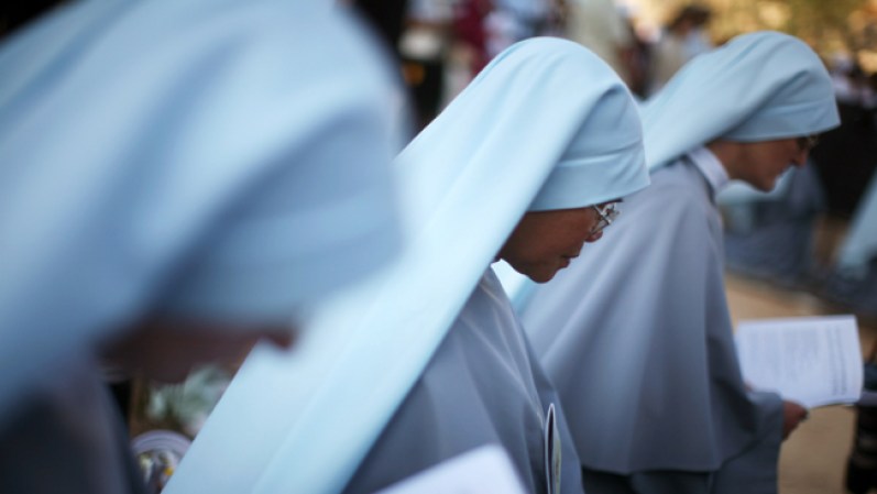 JERUSALEM - MAY 12: (ISRAEL OUT) Nuns pray as Pope Benedict celebrates a holy mass at the Kidron Valley May 12, 2009, nestled between the Mount of Olives and the Old City of Jerusalem. The German-born Pontiff visited holy sites in Jerusalem at the heart of the Israeli-Palestinian conflict on Tuesday as part of a pilgrimage marred by Jewish disappointment over his remarks on the Holocaust. (Photo by Uriel Sinai/Getty Images)