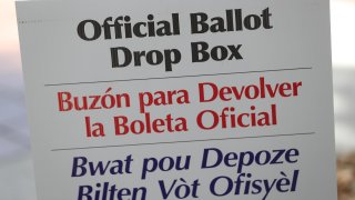 A sign directs voters to an official ballot drop box