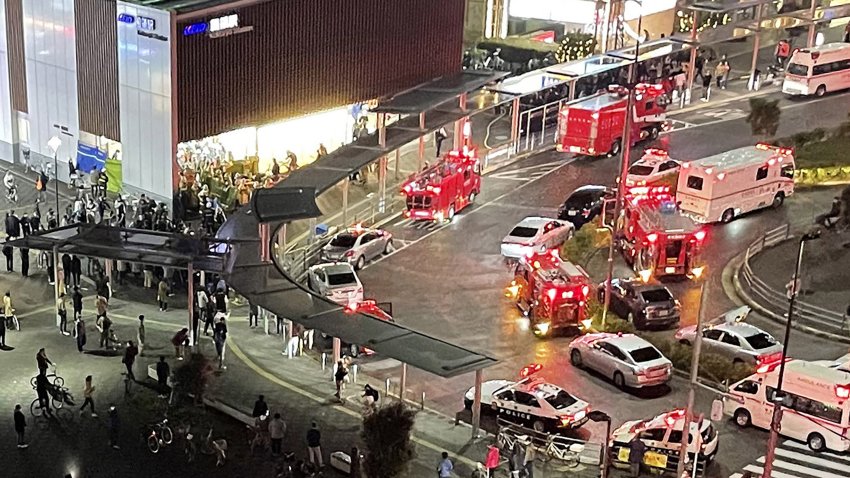 TOPSHOT – This aerial image shows firefighters and rescue workers gathered outside Kokuryo Station on the Keio Line in the city of Chofu in western Tokyo on October 31, 2021, after a man injured at least 10 people in a knife and fire attack on a train. – Japan OUT (Photo by JIJI PRESS / AFP) / Japan OUT (Photo by STR/JIJI PRESS/AFP via Getty Images)