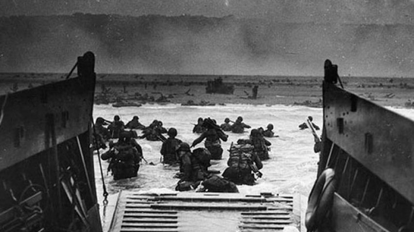 (FILES) This photograph from the National Archives taken on June 6, 1944, shows US Army troops wading ashore at Omaha Beach in north-western France, during the D-Day invasion. – In what remains the biggest amphibious assault in history, some 156,000 Allied personnel landed in France on June 6, 1944. An estimated 10,000 Allied troops were left dead, wounded or missing, while Nazi Germany lost between 4,000 and 9,000 troops, and thousands of French civilians were killed. The 75th anniversary of the D-day landings will fall on June 6, 2019. (Photo by Robert F. Sargent / STF / NATIONAL ARCHIVES / AFP /Getty Images)