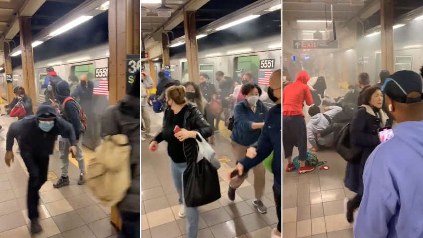 Riders run from a train car at the 36th Street subway station in Brooklyn's Sunset Park neighborhood in New York, April 12, 2022. A man had set off a smoke canister on a train car before shooting at fellow riders.