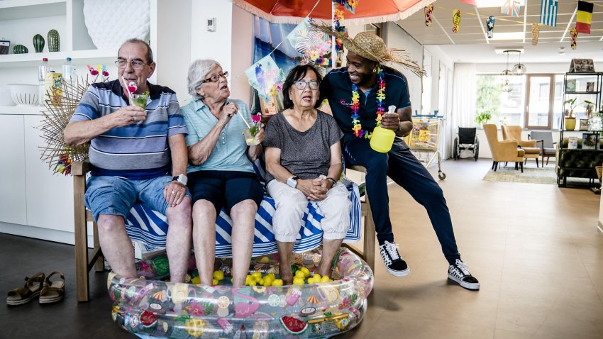 TOPSHOT – Residents of a care home sit with their feet in a swimming pool to cool off during a heatwave, in Zoetermeer, the Netherlands, on July 19, 2022. – Netherlands OUT (Photo by Bart Maat / ANP / AFP) / Netherlands OUT (Photo by BART MAAT/ANP/AFP via Getty Images)