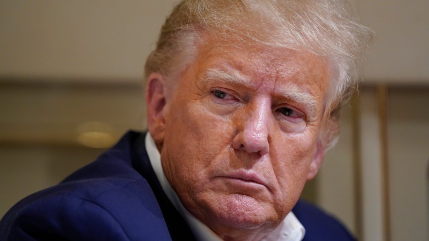 Former President Donald Trump listens as he speaks with reporters while in flight on his plane after a campaign rally at Waco Regional Airport, in Waco, Texas, March 25, 2023, while en route to West Palm Beach, Fla.