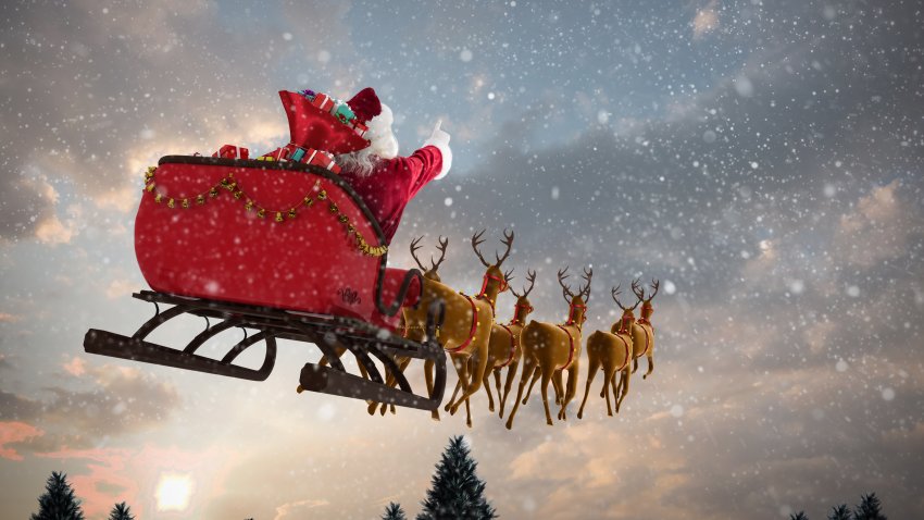 Santa Claus riding on sleigh with gift box against snow falling on fir tree forest