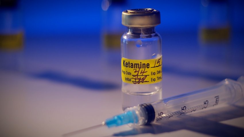 Ketamine vial with syringe in dramatic lighting