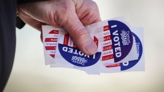 Person carries "I Voted" stickers.