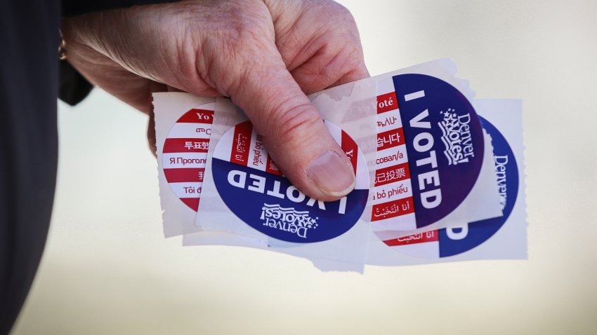 Person carries "I Voted" stickers.