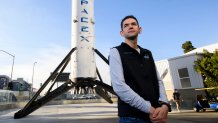 Inspiration4 mission commander Jared Isaacman, founder and chief executive officer of Shift4 Payments, stands for a portrait in front of the recovered first stage of a Falcon 9 rocket at Space Exploration Technologies Corp. (SpaceX) on February 2, 2021 in Hawthorne, California. - Isaacman's all-civilian Inspiration4 mission will raise 0 million for St. Jude Children's Research Hospital through a donation based sweepstakes to select a member of the crew. (Photo by Patrick T. FALLON / AFP) (Photo by PATRICK T. FALLON/AFP via Getty Images)