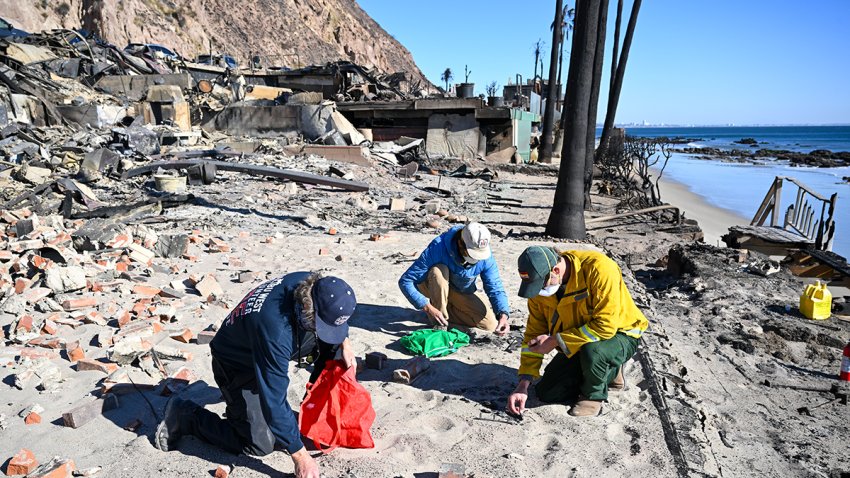 LOS ANGELES, CA – JANUARY 12: Residents look through for their valuables into ashes at their Malibu Beach burned home as Palisades wildfire continues in Los Angeles, California, United States on January 12, 2025. (Photo by Tayfun Coskun/Anadolu via Getty Images)