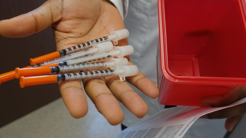 Hansel Tookes, a doctor at the University of Miami, holds needles on November 30, 2016, that will be given away to addicts at a new syringe exchange program, the first ever to open in a city where HIV rates are about double that of most major US cities.
Syringes, trash and homeless men line the broken sidewalk in a bleak section of downtown Miami where the state’s first-ever needle exchange program will open on December 1. / AFP / Kerry SHERIDAN / TO GO WITH AFP STORY by Kerry SHERIDAN, “Florida opens first needle exchange amid exploding HIV epidemic”        (Photo credit should read KERRY SHERIDAN/AFP via Getty Images)