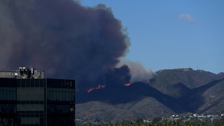 Plumes of smoke are seen as a brush fire burns in Pacific Palisafes as seen from Santa Monica, California on January 7, 2025. A fast-moving brushfire in a Los Angeles suburb burned buildings and sparked evacuations Tuesday as “life threatening” winds whipped the region. More than 200 acres (80 hectares) was burning in Pacific Palisades, a upscale spot with multi-million dollar homes in the Santa Monica Mountains, shuttering a key highway and blanketing the area with thick smoke. (Photo by Agustin PAULLIER / AFP) (Photo by AGUSTIN PAULLIER/AFP via Getty Images)