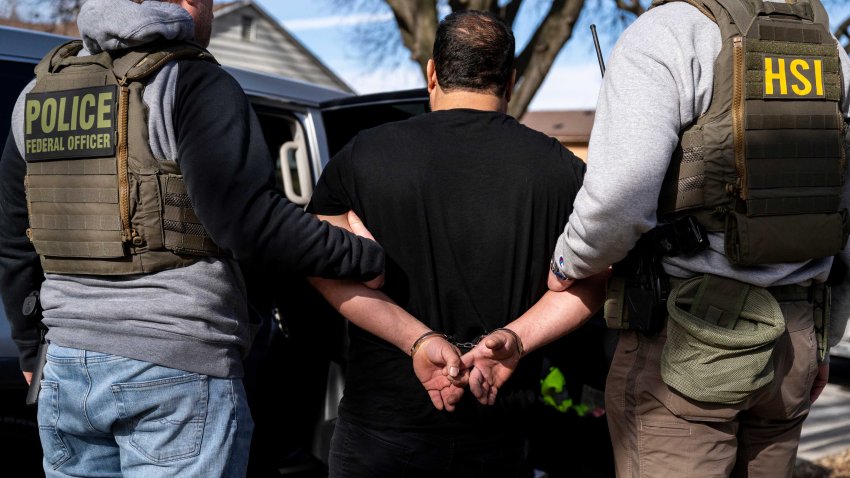 US Immigration and Customs Enforcement (ICE) agents detain a suspect during a multi-agency targeted enforcement operation in Lyons, Illinois, US, on Sunday, Jan. 26, 2025. President Donald Trump has pledged to carry out the largest deportation effort in US history, vowing to ultimately deport all of the foreigners living in the country without permission. Photographer: Christopher Dilts/Bloomberg via Getty Images