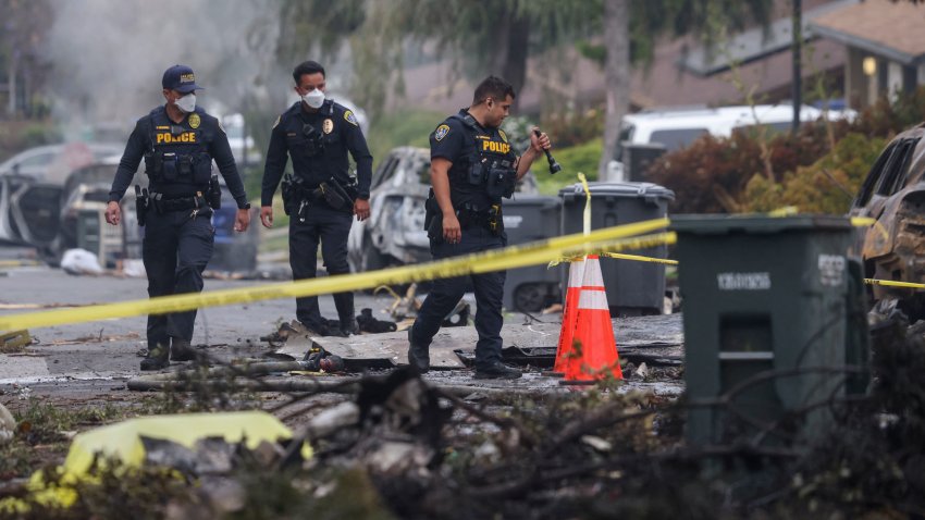 Investigators look through the site where a small plane crashed into a San Diego, California, residential street on May 22, 2025. The Federal Aviation Authority said a Cessna 550 crashed at around 3:45 am local time. The neighborhood is close to the Montgomery-Gibbs Executive Airport. The crash left a “gigantic debris field” and damaged some 15 homes and parked cars, ABC News quoted the San Diego assistant fire chief as saying. (Photo by Sandy Huffaker / AFP) (Photo by SANDY HUFFAKER/AFP via Getty Images)