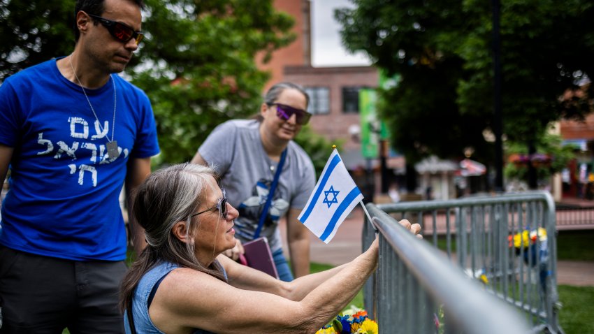 BOULDER, COLORADO – JUNE 2: Lisa Turnquist of Louisville, Colorado, lays flowers and a flag at the site of the attack outside the Boulder County Courthouse on June 2, 2025 in Boulder, Colorado. A suspect is in custody after reportedly throwing incendiary devices at a group participating in an organized walk to show solidarity with hostages held by Hamas in Gaza. The suspect, an Egyptian citizen who had overstayed his visa, has been charged with a hate crime by the F.B.I.  (Photo by Chet Strange/Getty Images)