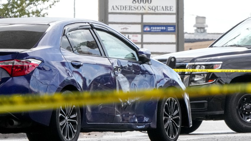 A vehicle with a damaged door and broken window is left in the street after an I.C.E. shooting at the intersection of Anderson Square and Research Boulevard on Sunday, Sep. 20, 2026 in North Austin.
